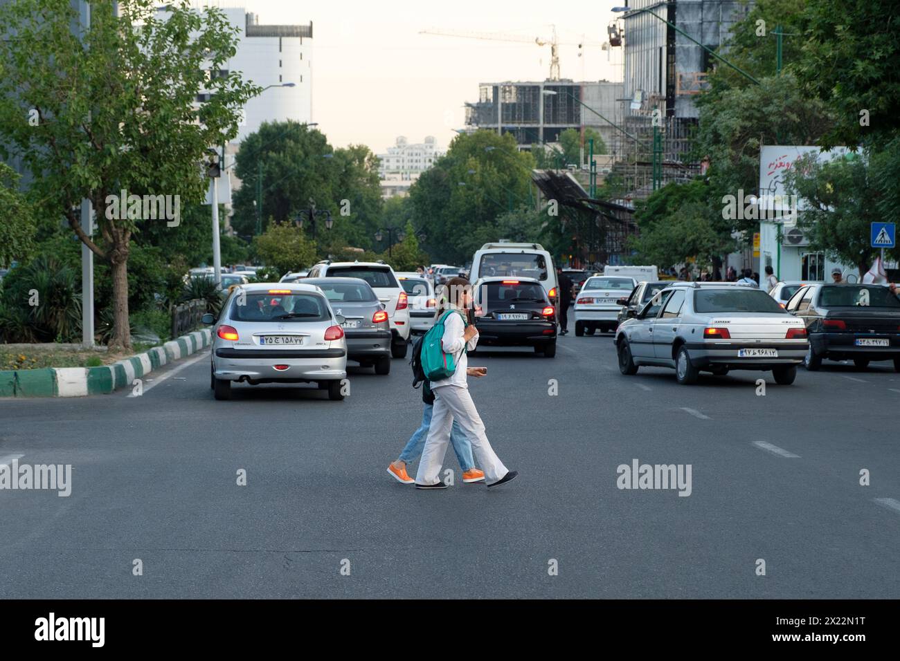 Two Iranian Girls in Tehran fighting against compulsory hijab by walking without scarfs in public. Stock Photo