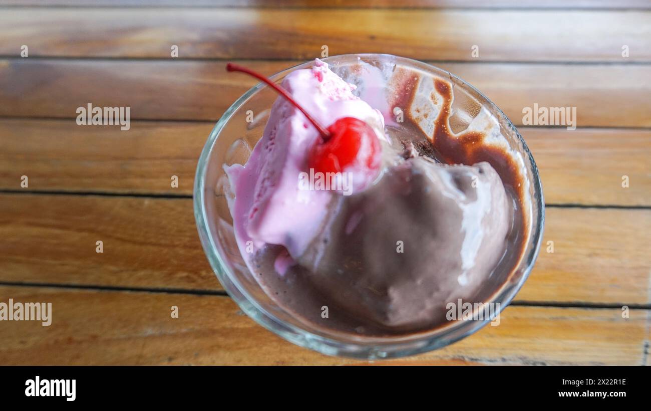 Chocolate and strawberry flavored ice cream with cherry on top Stock Photo