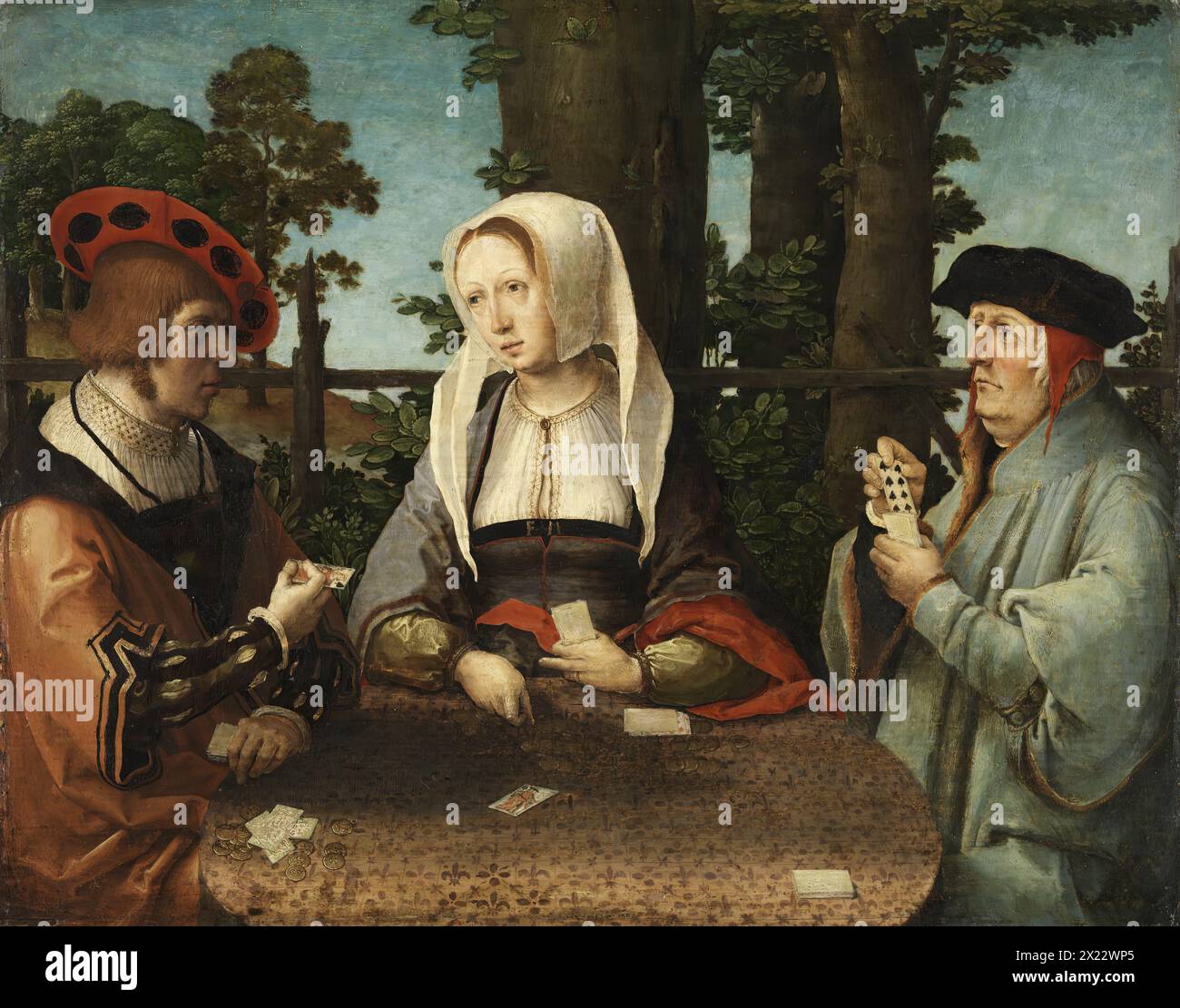 The Card Players, 1520. A woman flanked by two men seated around a circular table that occupies the foreground of the painting. On the table top, which has a print of fleurs-de-lys, are a number of small stacks of cards and piles of money. The woman, positioned frontally, points to the jack of spades while the young man on our left has the king of spades in his hand and looks at the other man who shows him the eight of spades. The scene takes place in an exterior that contains a limited number of elements, including a tree trunk, a rustic fence and an area of blue sky. It has been suggested th Stock Photo