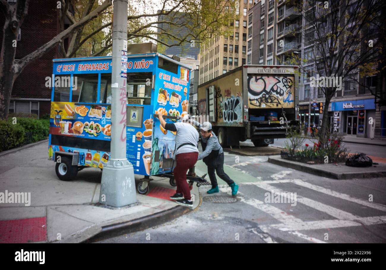 Food cart workers maneuver their cart off the sidewalk and into the road at the end of their day on Wednesday, April 17, 2024. (© Richard B. Levine) Stock Photo