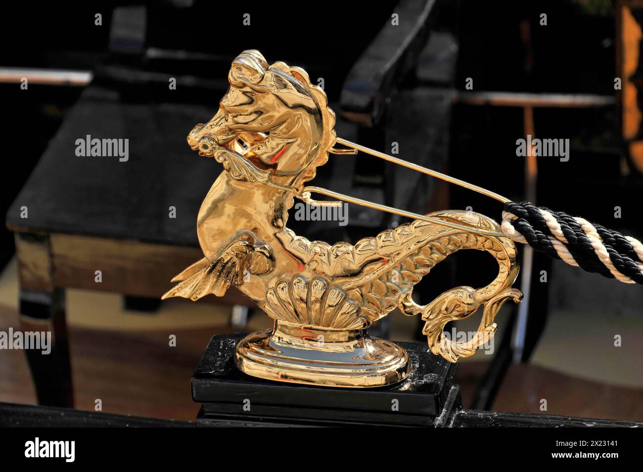Close-up of a shiny golden seahorse figure on a Venetian gondola, Venice, Veneto, Italy Stock Photo