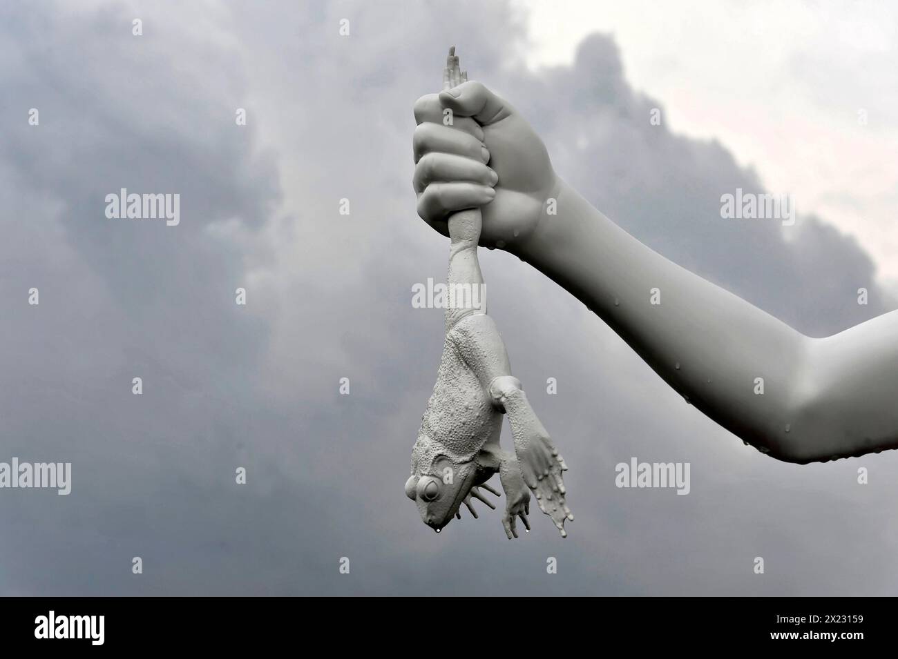 Charles Ray's statue of the boy with a frog on the top of the Zattere A surreal sculpture of a hand holding a key with a frog hanging out of it Stock Photo
