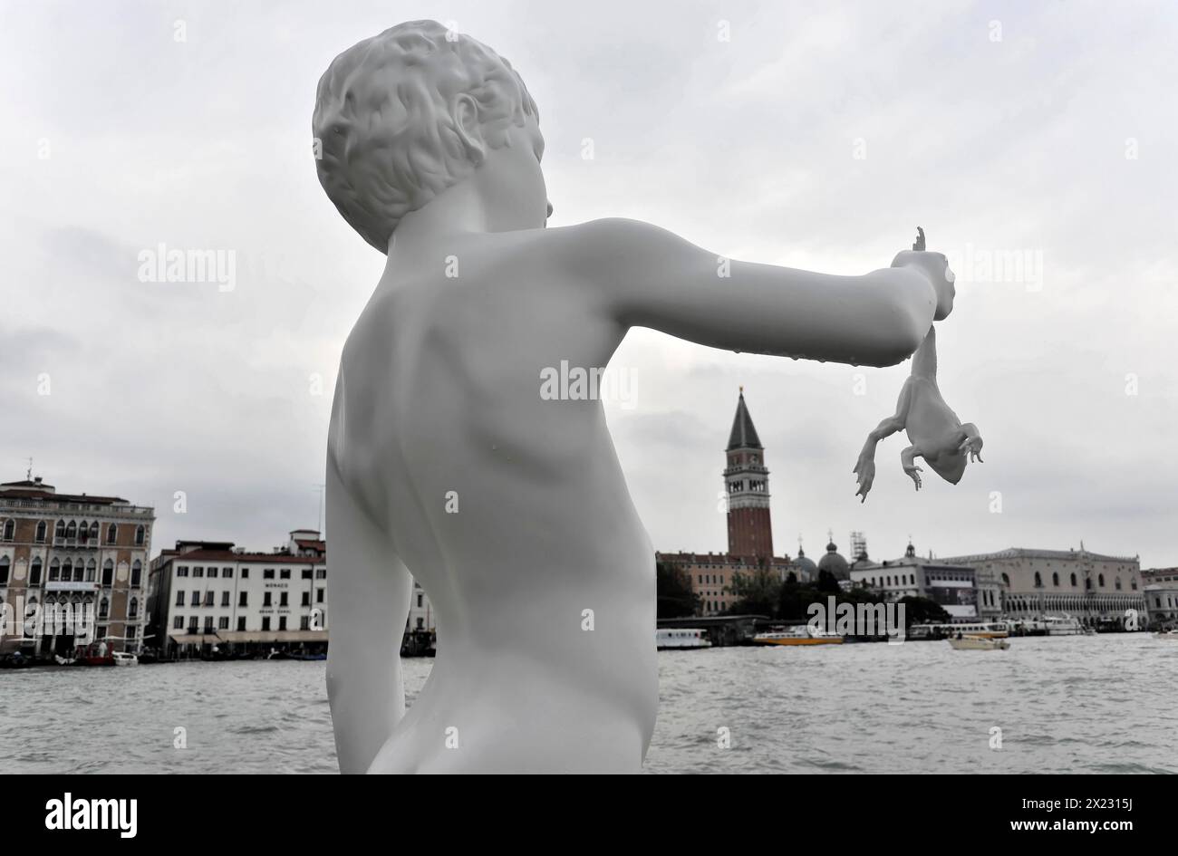 Charles Ray's statue of the boy with a frog on the top of the Zattere, detail of a surrealist sculpture with a white hand holding a frog, Venice Stock Photo