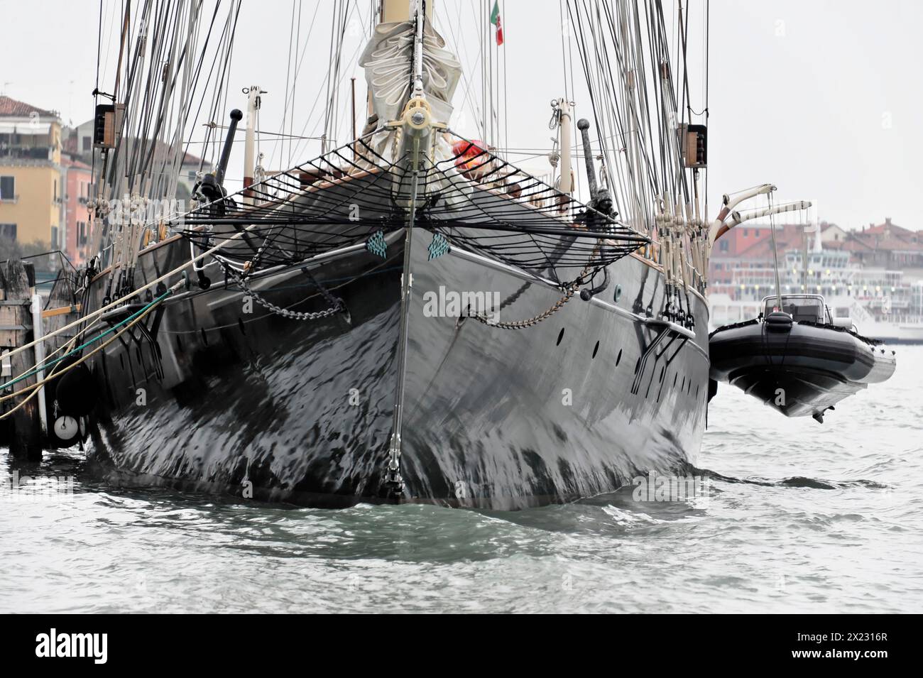 Black sailing ship with several masts on moving water, Venice, Veneto, Italy Stock Photo