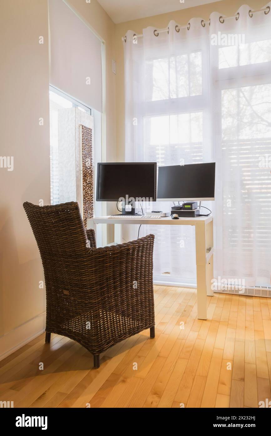 Wicker Table Computer Brown high-back wicker chair and white desk table with computer in home ...