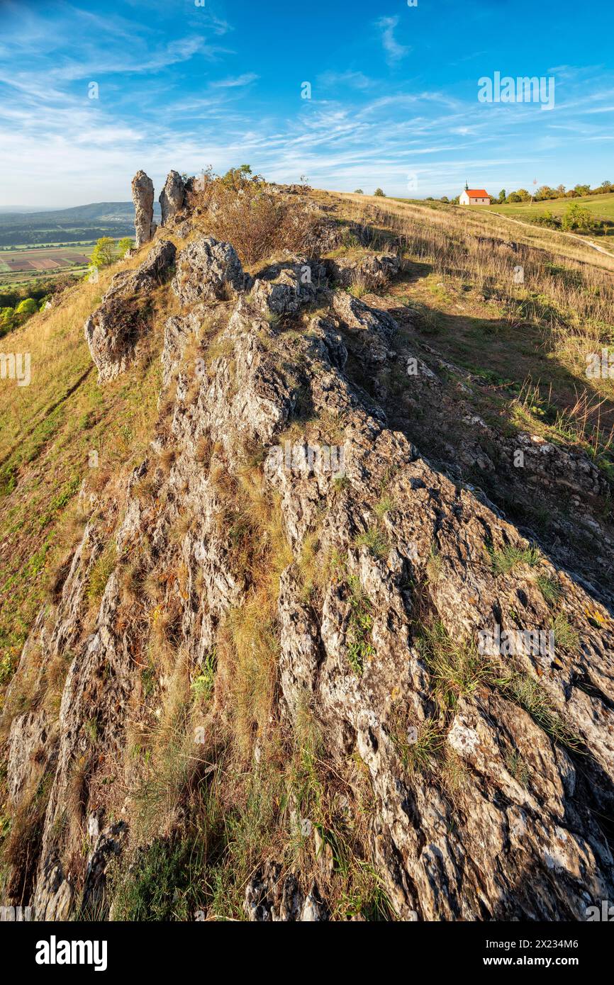 Evening on the Ehrenbuerg witness mountain, also known as Walberla, with Walburgis Chapel and Wiesenthauer Nadel rock formation, Veldensteiner Forst Stock Photo