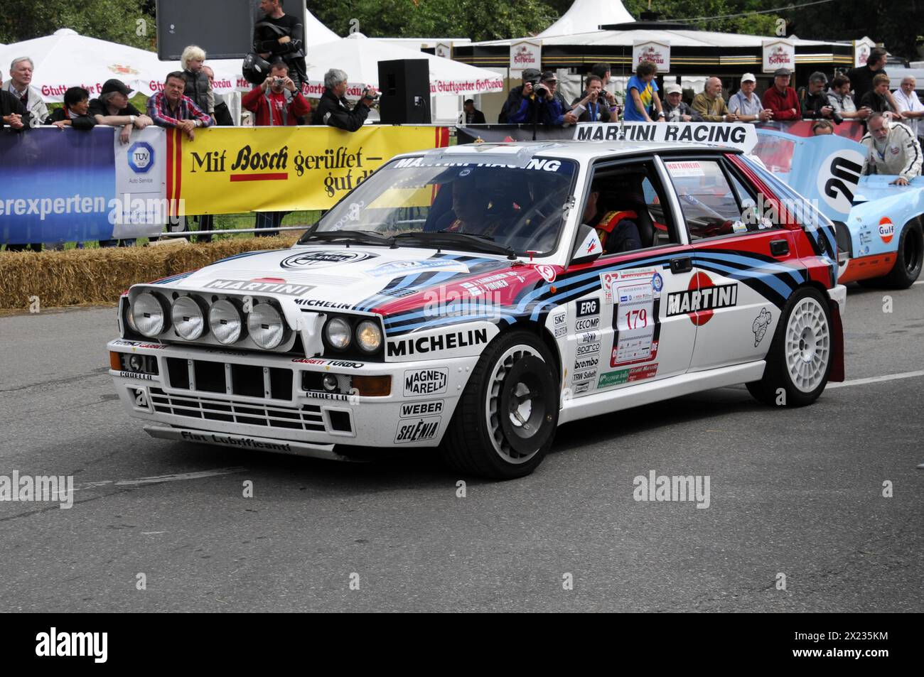 A Lancia rally car with Martini Racing stickers drives past spectators on a road, SOLITUDE REVIVAL 2011, Stuttgart, Baden-Wuerttemberg, Germany Stock Photo