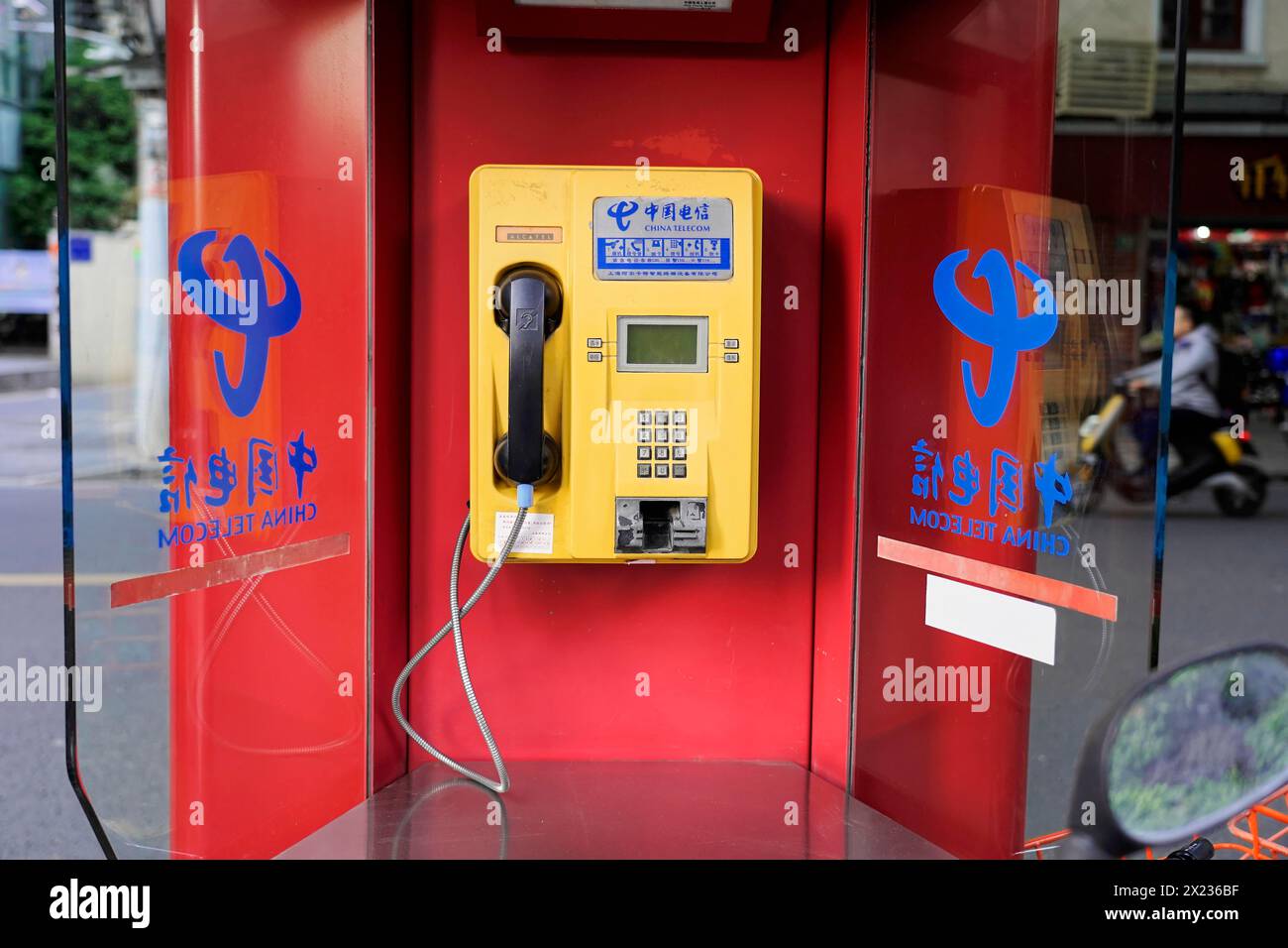 Shanghai, China, Asia, Red public telephone box with Chinese characters and reflections in glass, People's Republic of China Stock Photo