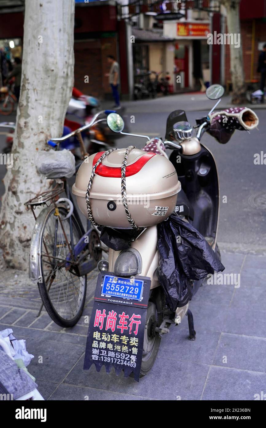 Shanghai, China, Asia, Parked scooter and bicycle on a roadside with parking signs in Chinese, People's Republic of China Stock Photo