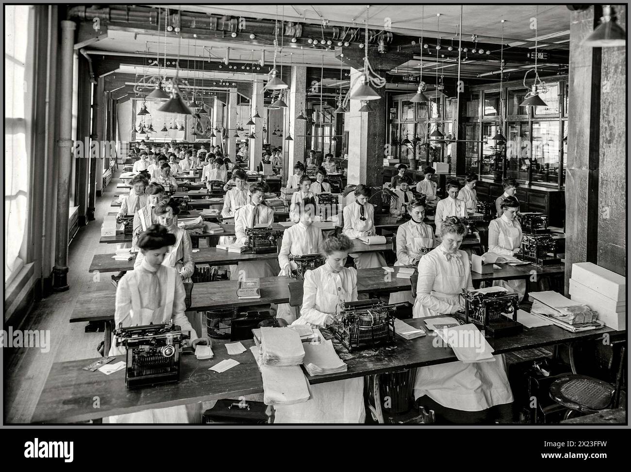 Vintage Typing Typewriting Office Bureau Department in Dayton, Ohio, USA circa 1902. 'Typewriting department, National Cash Register.'  NCR with a large room staffed entirely by women in light formal clothing seated at their typewriters photographed by William Henry Jackson Stock Photo