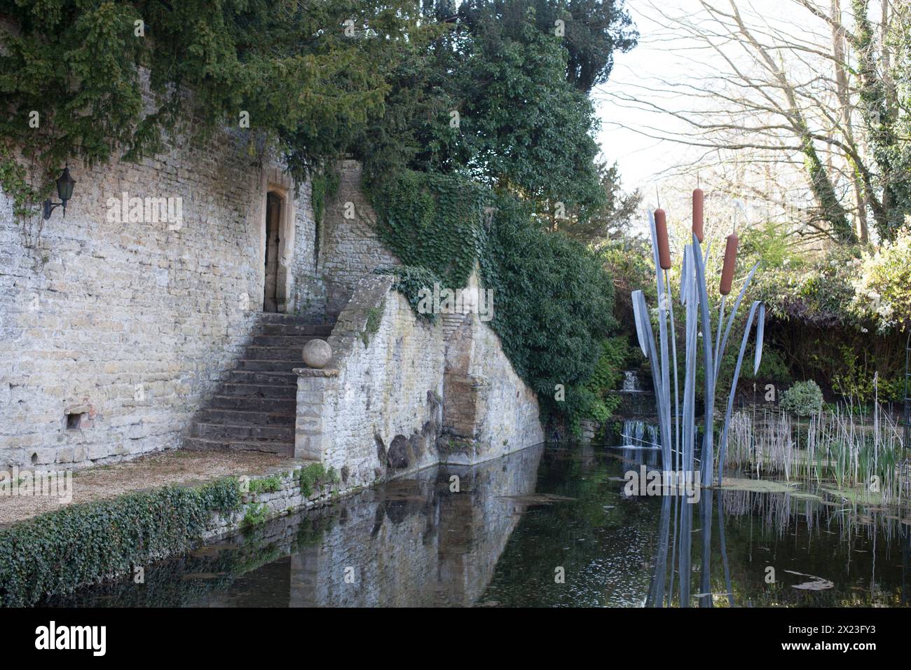 A statue of water plants and a dragonfly in the grounds of Le Manoir