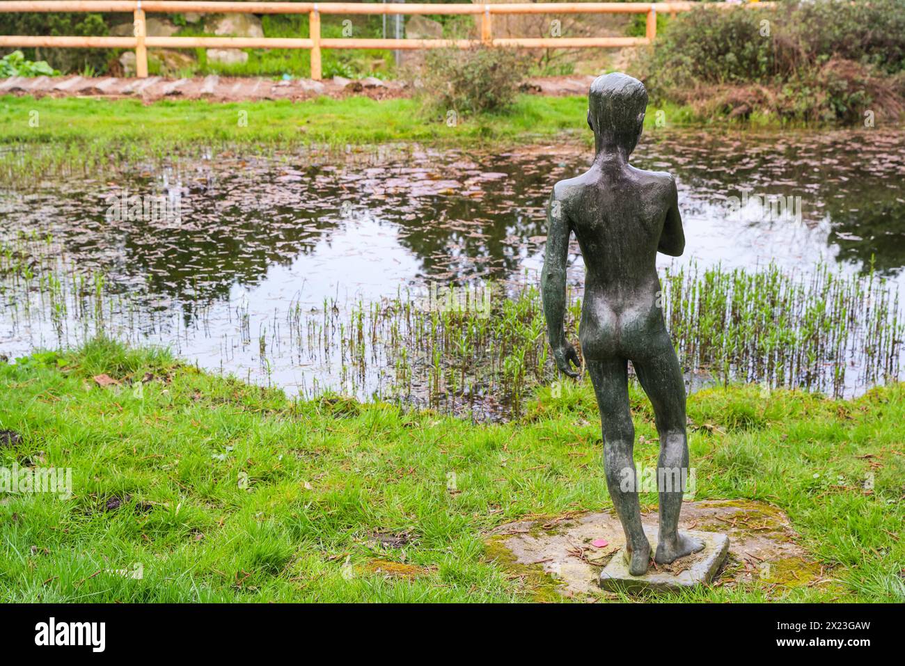 Boy with Fish, sculpture by Ernst Hackländer at pond, Gruga, Grugapark, Essen, Germany Stock Photo