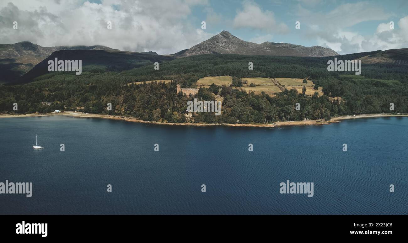 Scotland mountain Goatfell landscape aerial panoramic view at Brodick Harbour, Arran Island. Majestic Scottish nature scenery of forests, meadows and medieval castle. Stock Photo