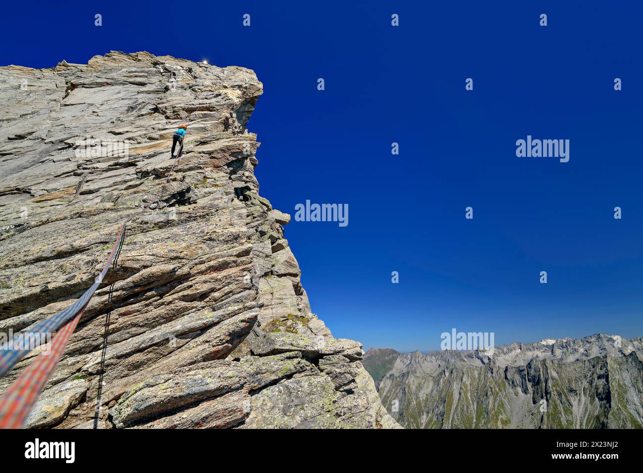 Woman climbing abseiling from the Zsigmondyspitze, Zsigmondyspitze, Zillertal Alps, Zillertal Alps Nature Park, Tyrol, Austria Stock Photo