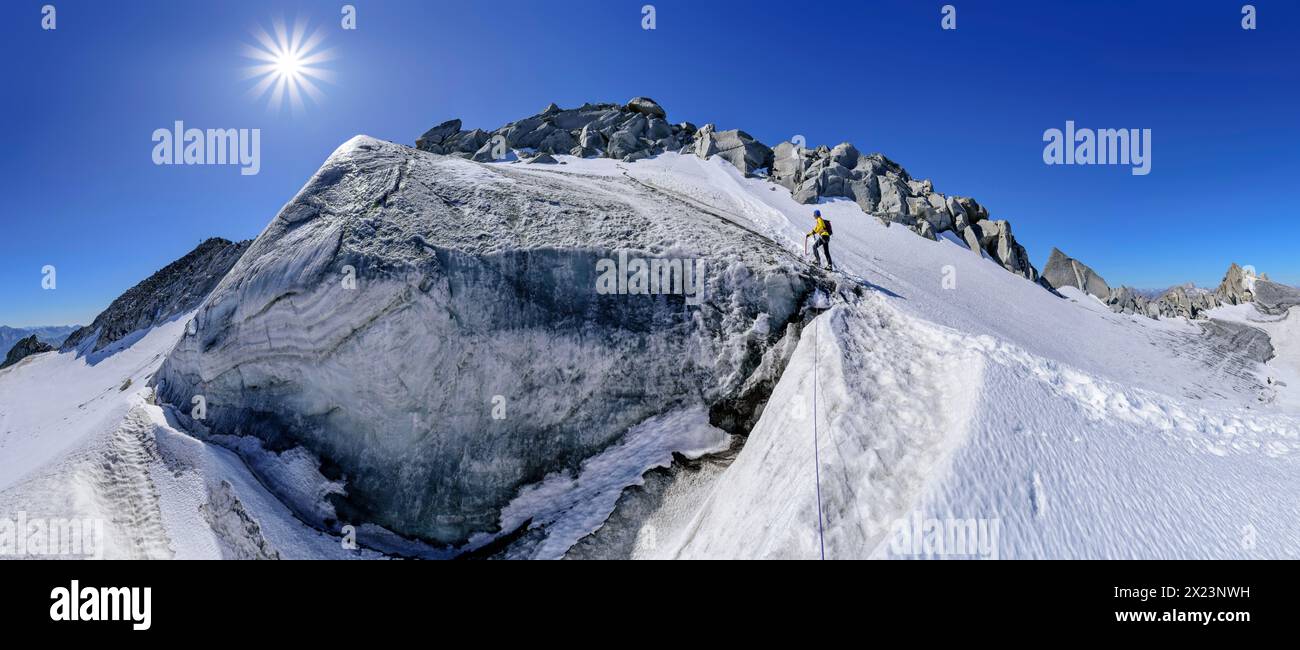 Panorama with woman mountaineering rising over glacier, Schwarzensteinkees, Schwarzenstein, Zillertal Alps, Zillertal Alps Nature Park, Tyrol, Austria Stock Photo
