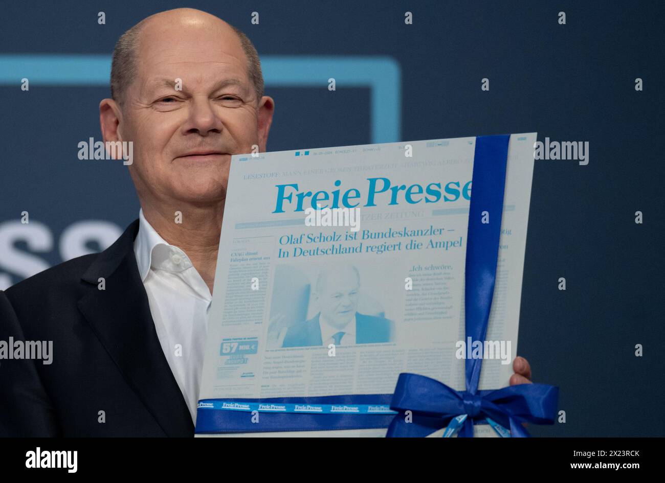 Chemnitz, Germany. 19th Apr, 2024. Federal Chancellor Olaf Scholz (SPD) holds a printing plate from the daily newspaper "Freie Presse" with the announcement of his chancellorship. He was given the offset plate as a gift after the readers' debate. Topics of discussion included the wars and crises in the world, the current social situation in Germany and immigration and its consequences. Credit: Hendrik Schmidt/dpa/Alamy Live News Stock Photo