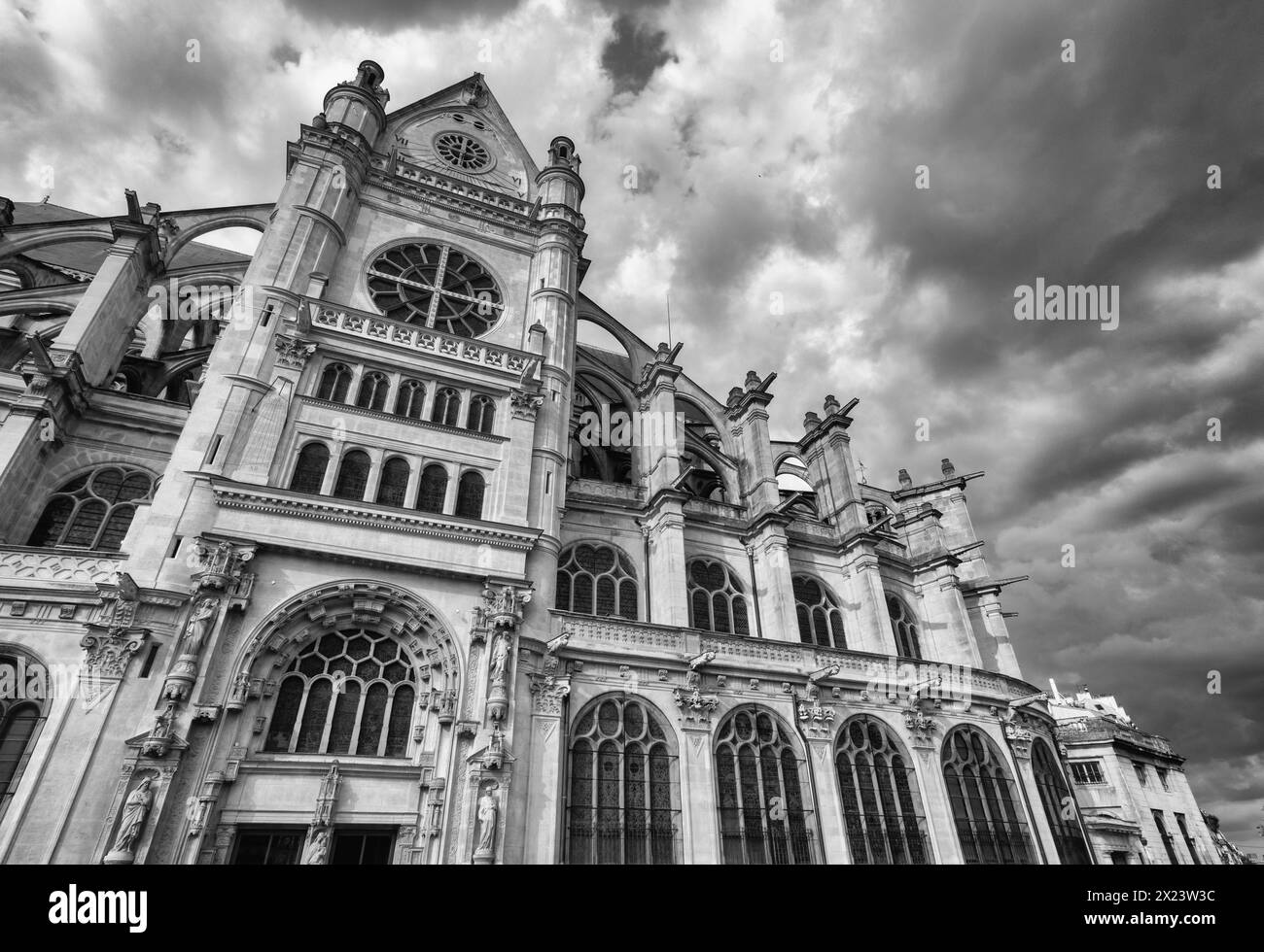 The Church of Saint-Eustache, c1633,  Paris, France Black and White with dramatic sky Stock Photo