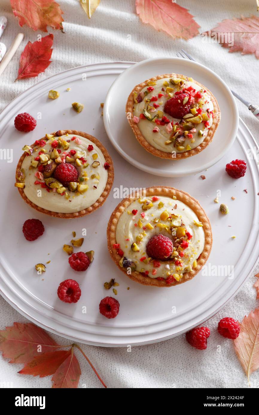 Pistachio mousse tartlets with raspberries Stock Photo - Alamy