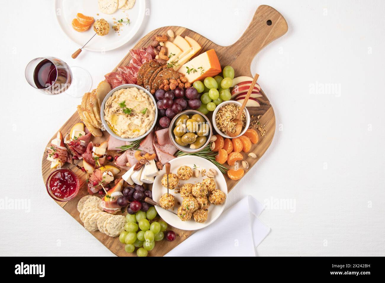 Fruit and nut board with cheese, ham and sausage Stock Photo