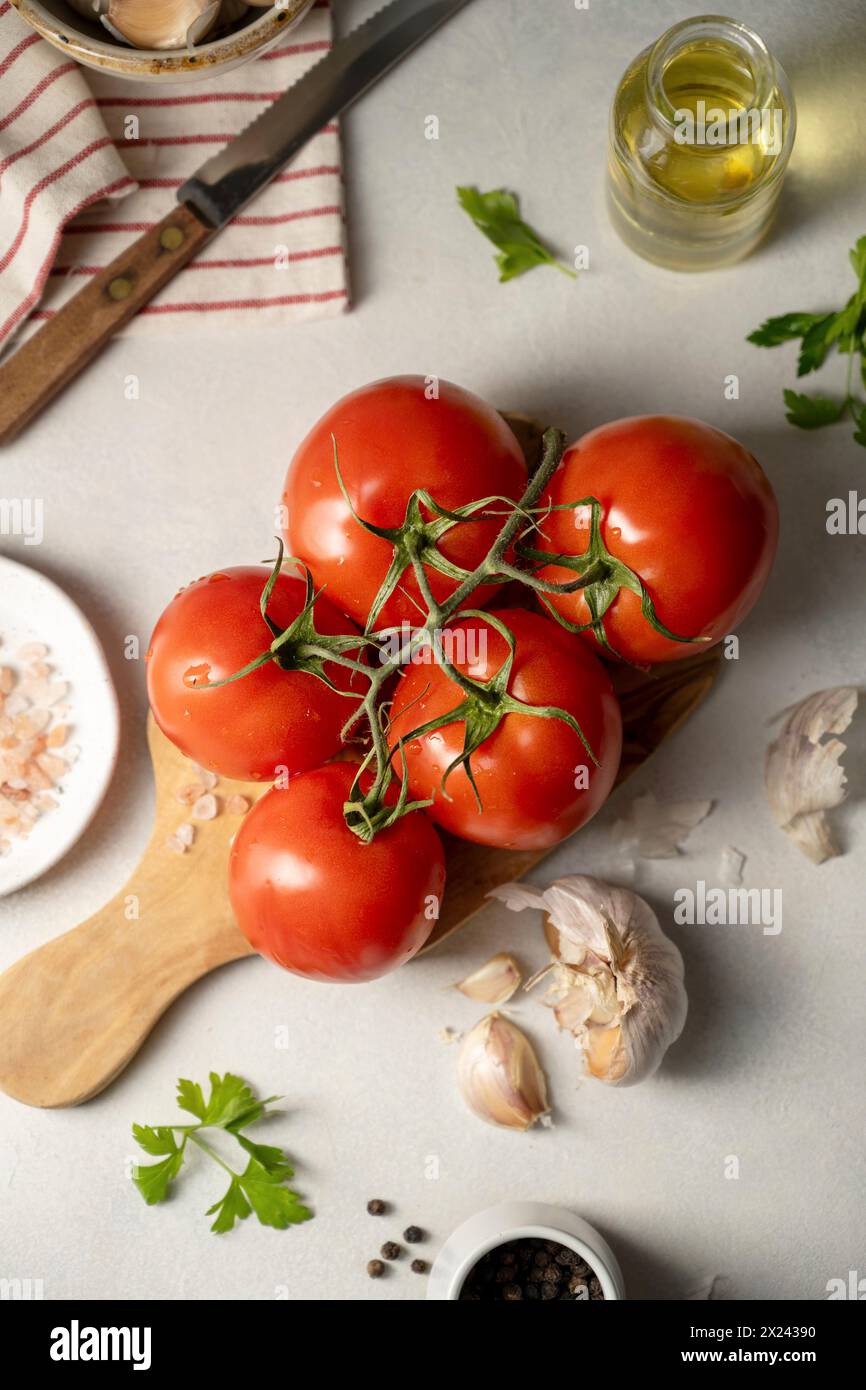 Vine tomatoes and ingredients for tomato sauce Stock Photo