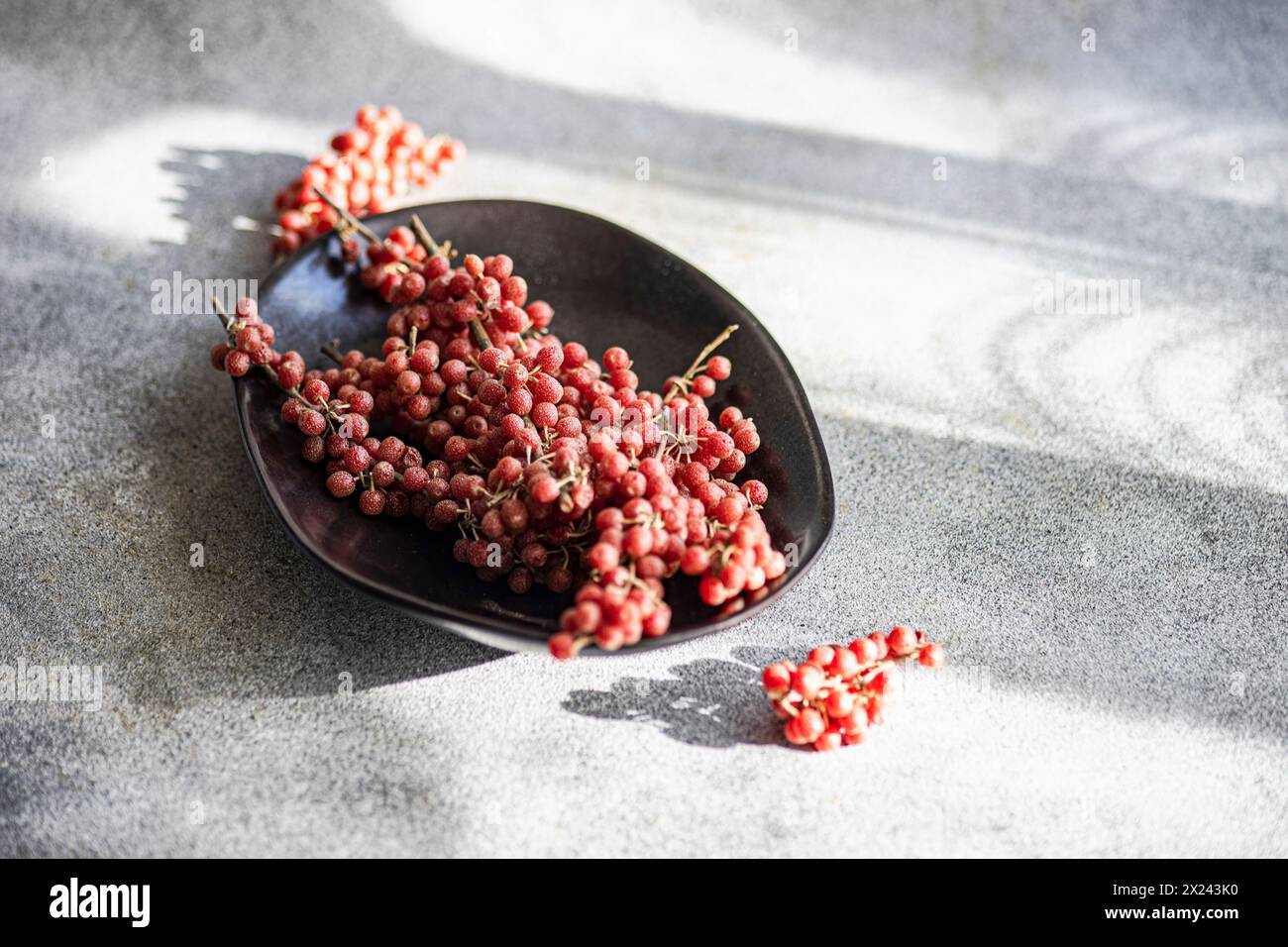 Buffalo berries in a black bowl Stock Photo