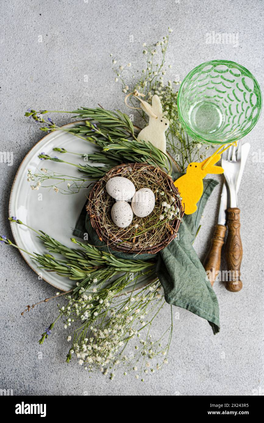 Festive place setting with nest and eggs for Easter Stock Photo