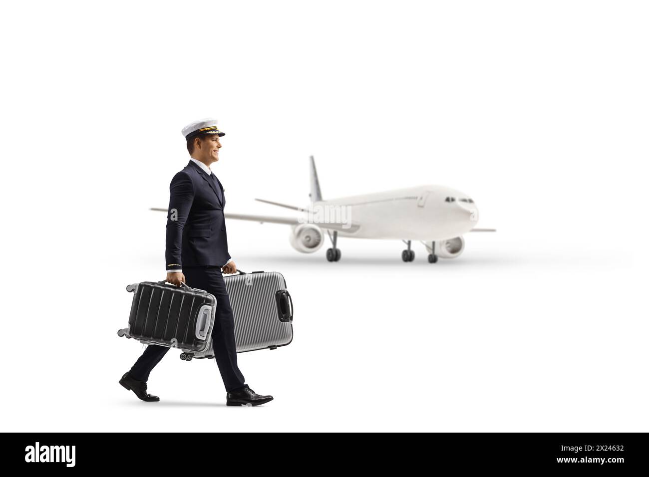 Full length profile shot of a pilot walking and carrying suitcases near a plane isolated on white background Stock Photo