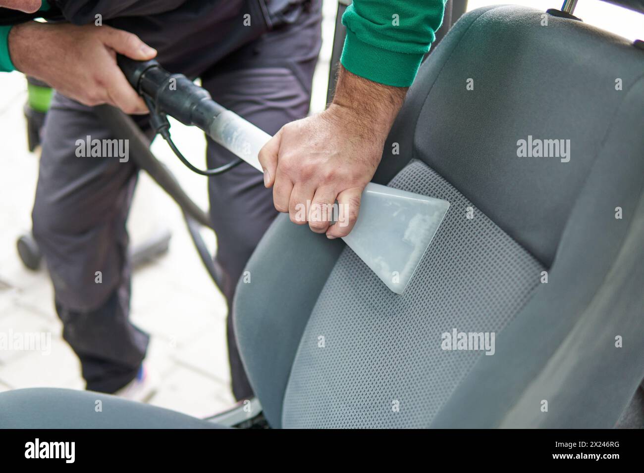 Car cleaning detailing male using professional steam vacuum chemical