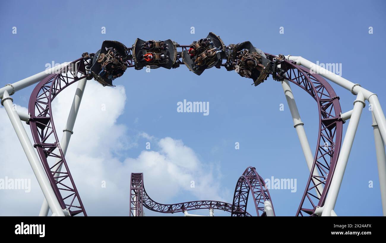 Young people have fun on 'The Ride to Happiness' extreme spinning rollercoaster at the 'Plopsaland De Panne' theme park Stock Photo