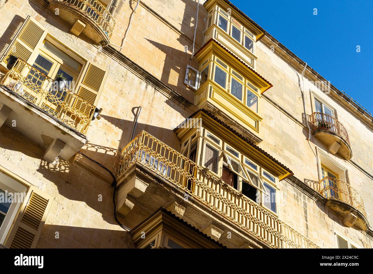 Valletta, Malta, April 03, 2024. view of the typical wooden balconies in the old buildings in the city center Stock Photo