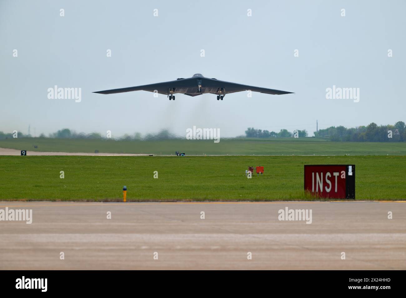 A B-2 Spirit stealth bomber assigned to the 509th Bomb Wing takes off at Whiteman Air Force Base, Mo., April 15, 2024. Team Whiteman executed a mass fly-over of 12 B-2 Spirit stealth bombers to cap off the annual Spirit Vigilance exercise. Routine training ensures that Airmen are always ready to execute global strike operations… anytime, anywhere.. (U.S. Air Force photo by Airman 1st Class Matthew S. Domingos) Stock Photo