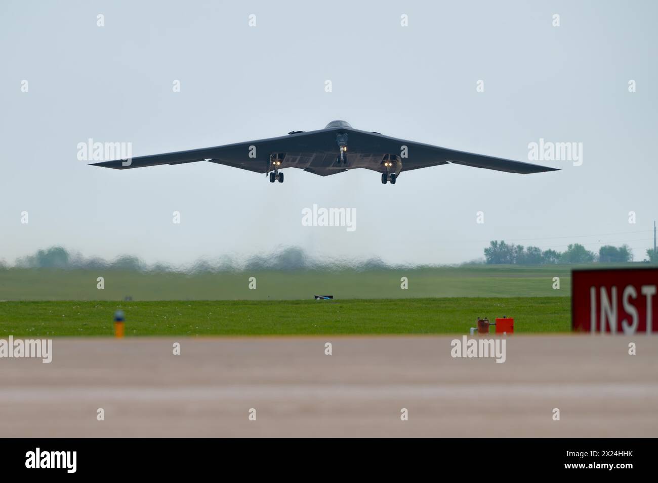 A B-2 Spirit stealth bomber assigned to the 509th Bomb Wing takes off at Whiteman Air Force Base, Mo., April 15, 2024. Team Whiteman executed a mass fly-over of 12 B-2 Spirit stealth bombers to cap off the annual Spirit Vigilance exercise. Routine training ensures that Airmen are always ready to execute global strike operations… anytime, anywhere.. (U.S. Air Force photo by Airman 1st Class Matthew S. Domingos) Stock Photo