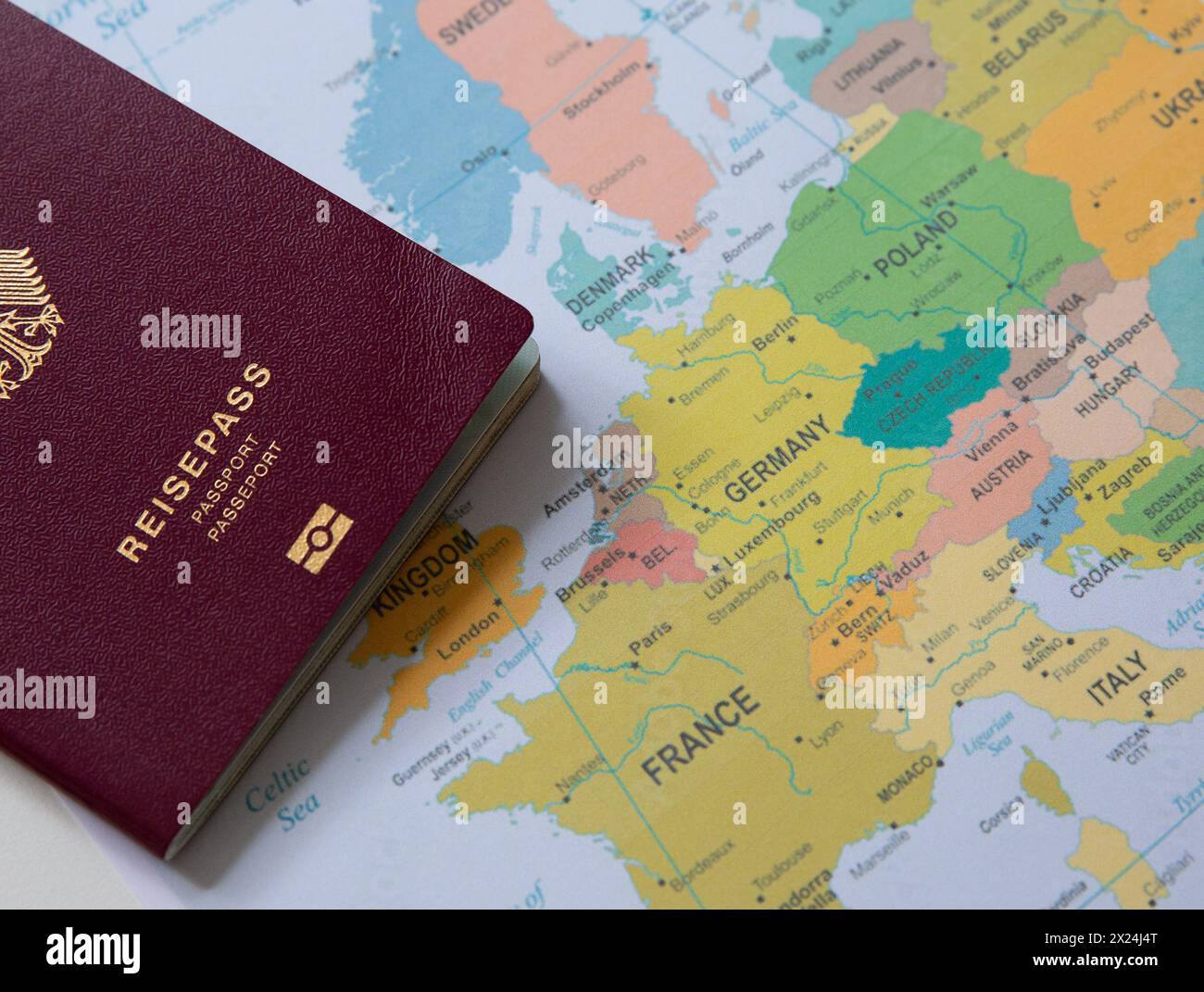 Close up of a German passport on colorful Europe map background Stock Photo