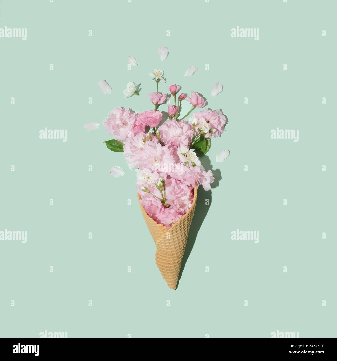 Ice cream cone with Japanese cherry blossoms on pastel mint background ...