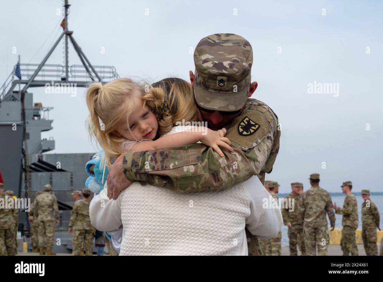 Fort Eustis, Virginia, USA. 1st Apr, 2024. A U.S. Soldier assigned to USAV M.G. Charles P. Gross (LSV-5) hugs his wife and daughter before deploying from Joint Base Langley-Eustis, Virginia, April 1st, 2024. The USAV M.G. Charles P. Gross deployed to provide logistical support and establish a roll-on roll-off pier capability that allows ship-to-shore humanitarian assistance to the people of Gaza. (Credit Image: © Zulema Sotelo/U.S. Air Force/ZUMA Press Wire) EDITORIAL USAGE ONLY! Not for Commercial USAGE! Stock Photo