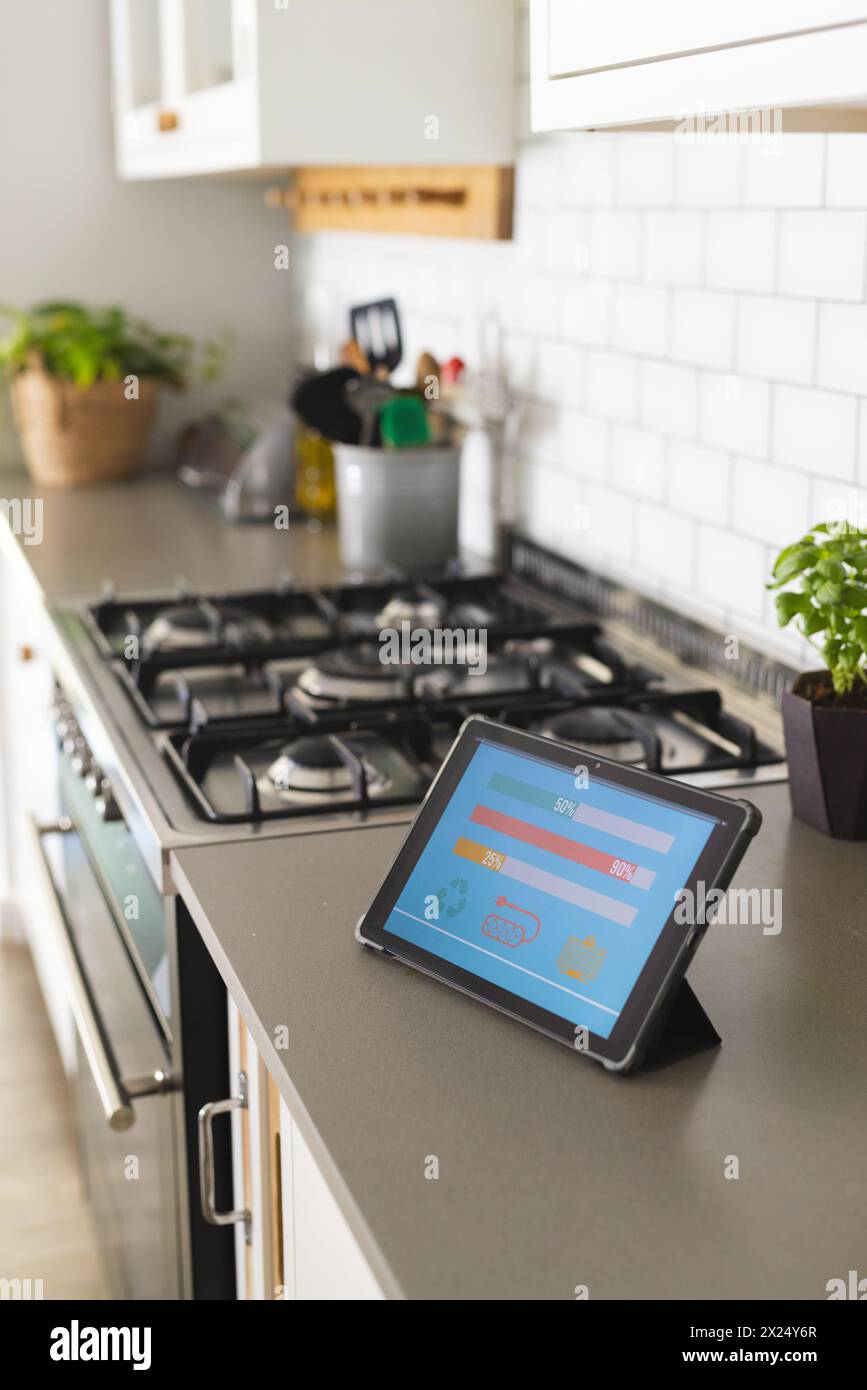 Smart home app energy usage on tablet in kitchen at home Stock Photo