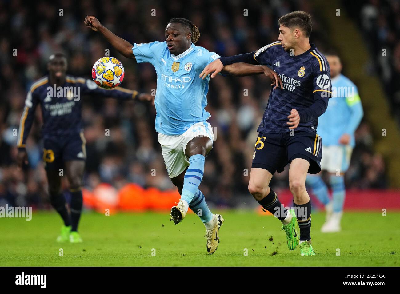Jeremy Doku of Manchester City and Fede Valverde of Real Madrid during the UEFA Champions League match, Quarter-finals, second leg, between Manchester City and Real Madrid played at Ethiad Stadium on April 17, 2024 in Manchester, England. (Photo by Bagu Blanco / PRESSINPHOTO) Stock Photo