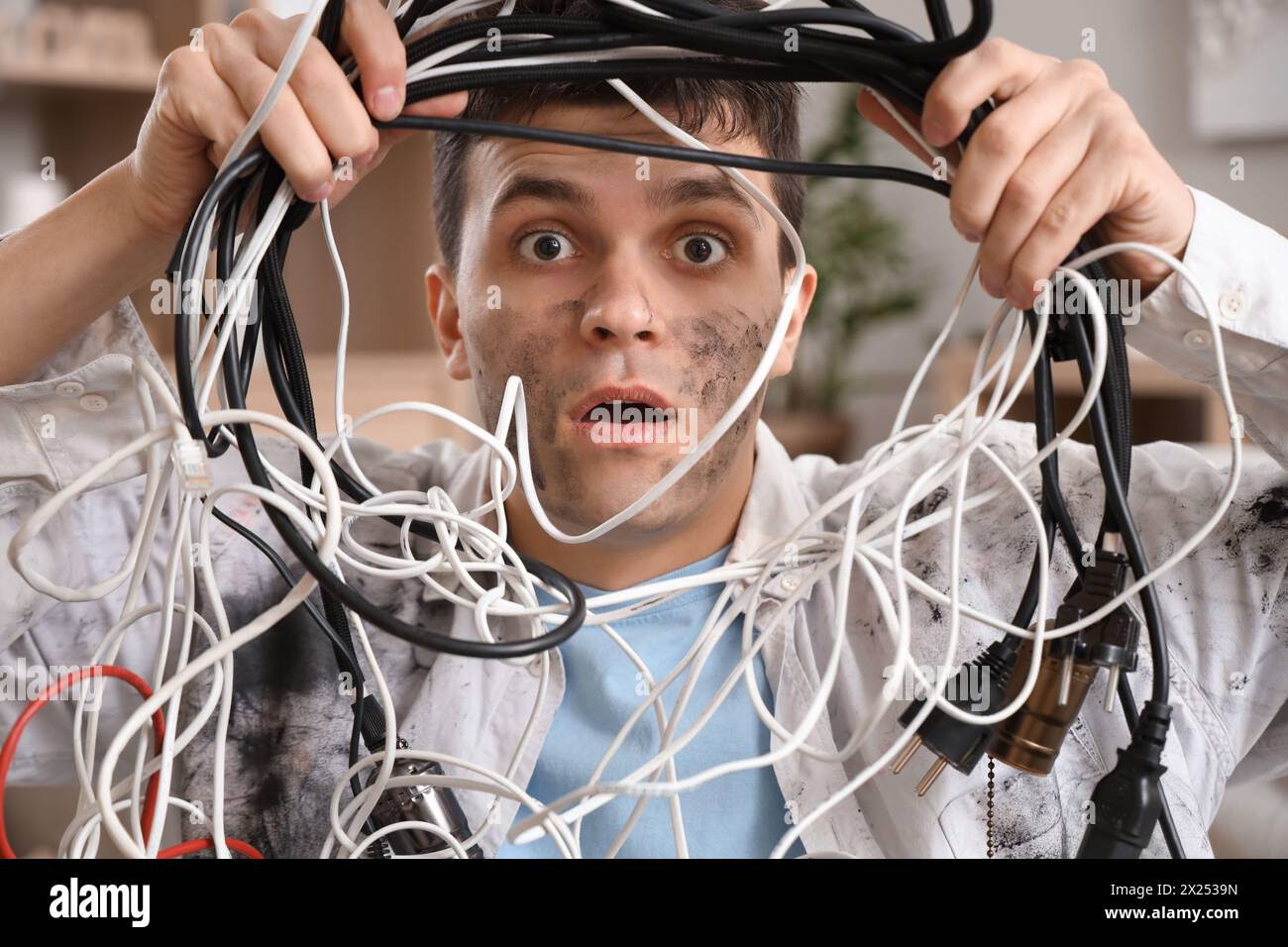 Electrocuted man with burnt face and wires at home, closeup Stock Photo