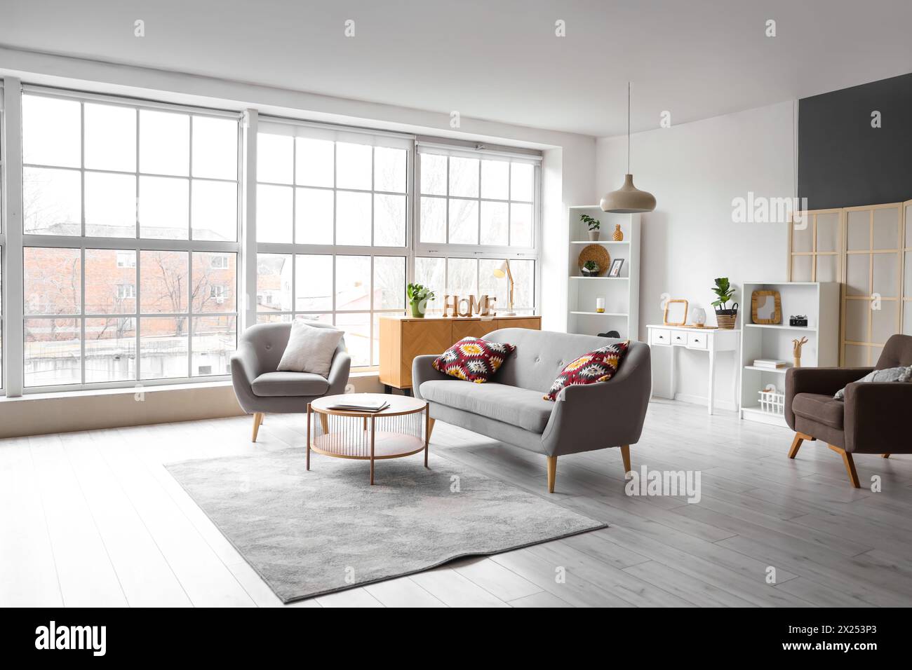 Interior of modern living room with grey armchair, sofa and table Stock ...