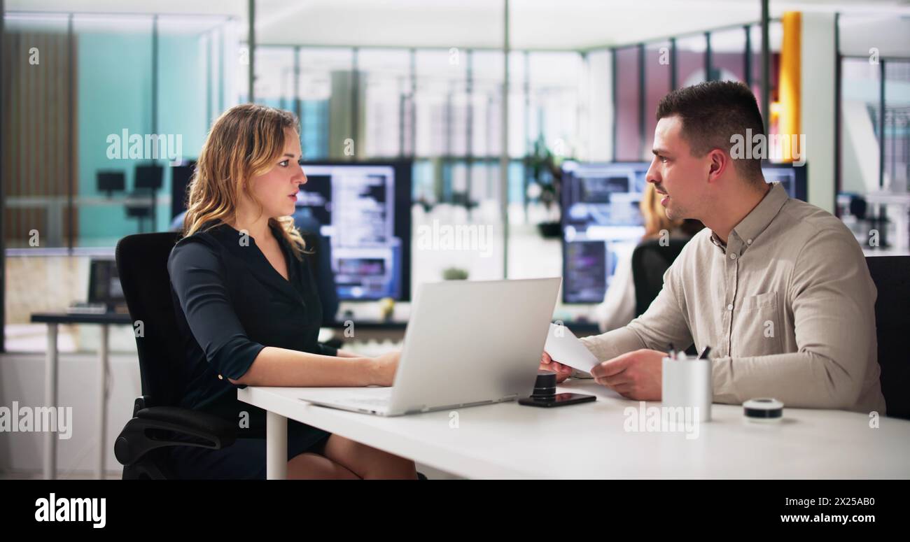 Young Happy Businesspeople Talking With Each Other In Office Stock Photo