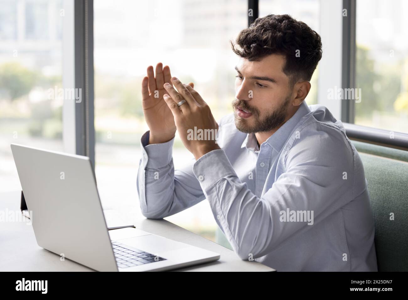 Serious young Arab project manager man talking to client Stock Photo