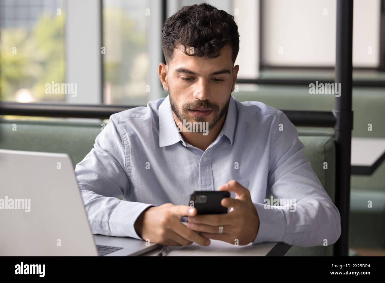 Focused handsome Arab freelance professional man using modern online technology Stock Photo