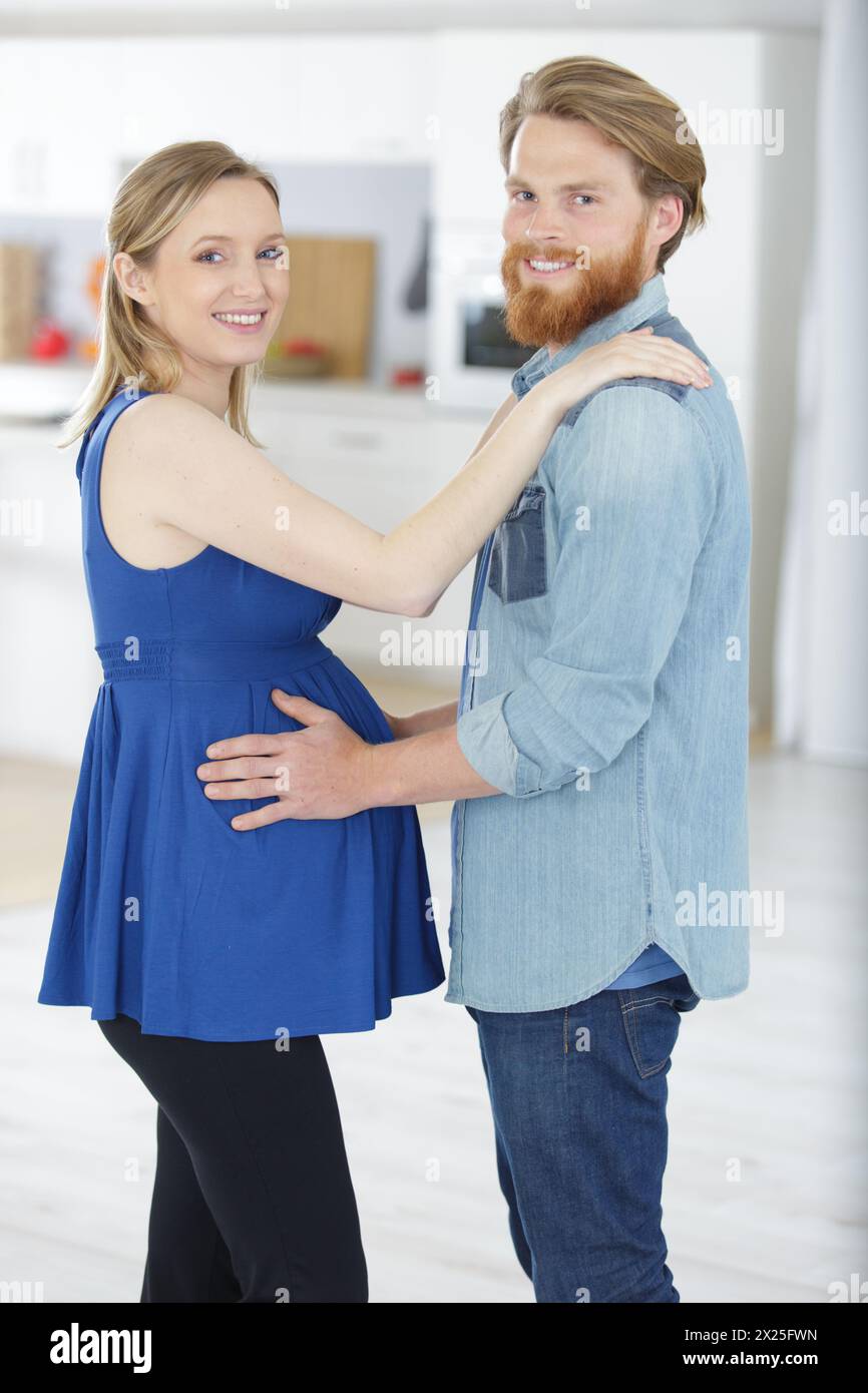 happy man hugging his pregnant wife at home Stock Photo - Alamy