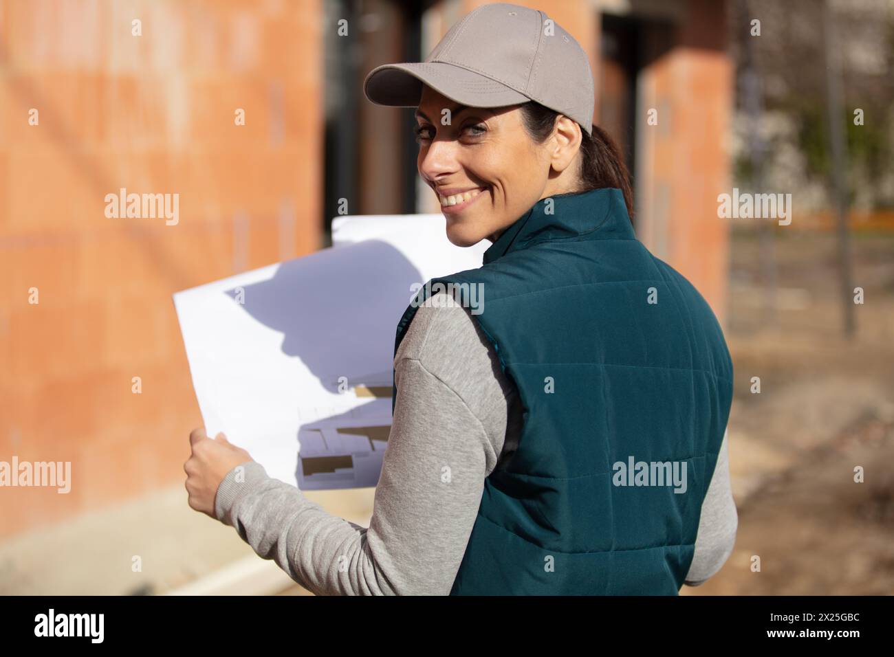 beautiful female engineer doing job at construction site outside Stock Photo