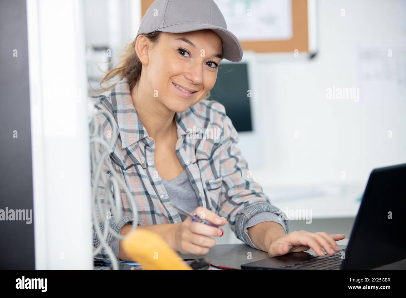 female programmer coding on a desktop computer Stock Photo