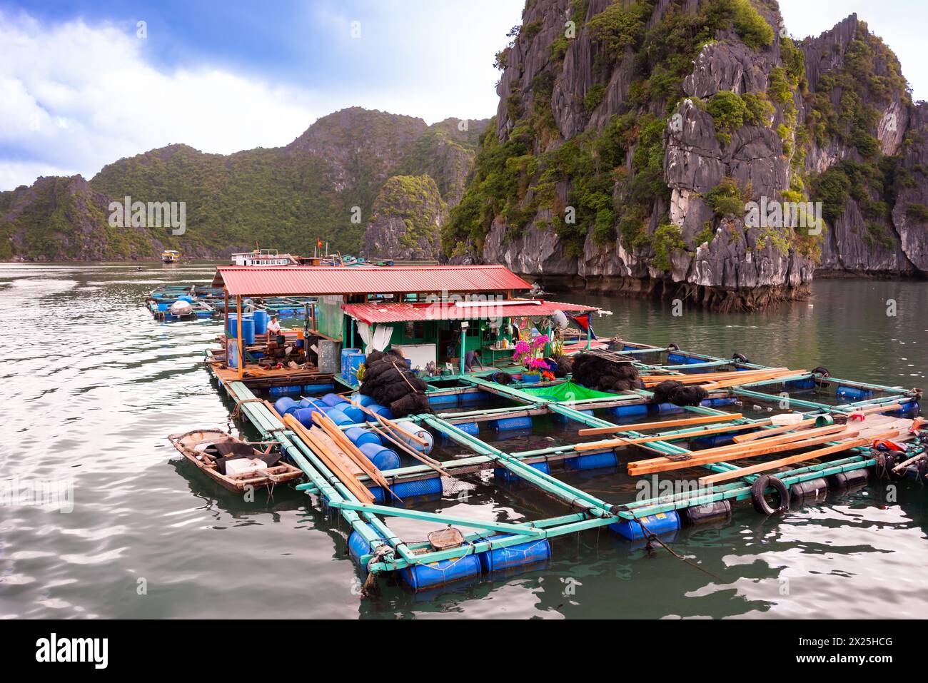 Floating village in sea bay in Vietnam Stock Photo - Alamy
