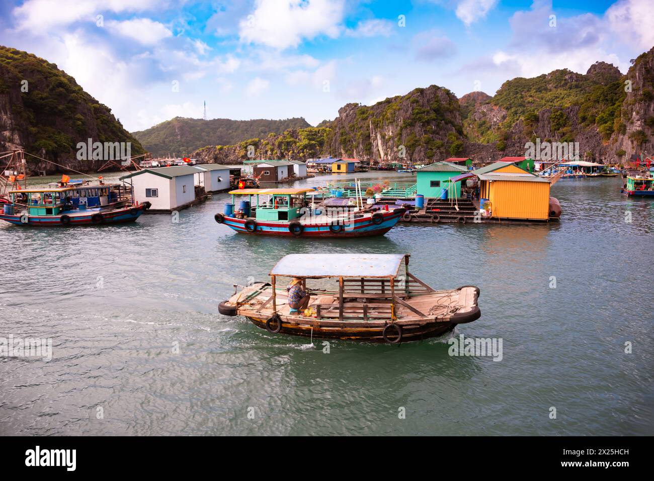 Floating village in sea bay in Vietnam Stock Photo - Alamy
