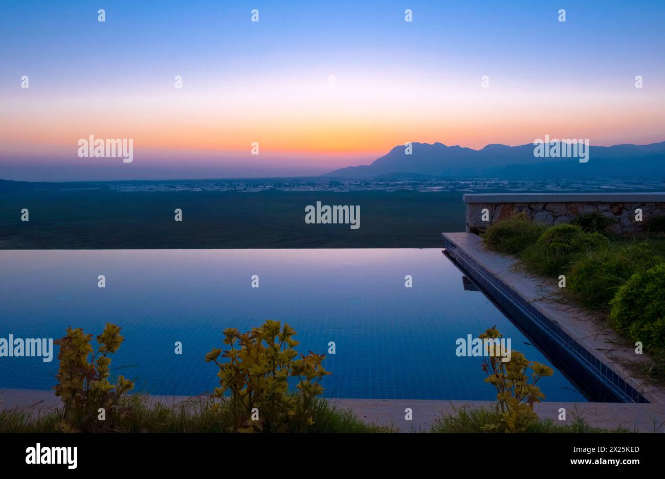 Sunset long exposure blue hour shot with pool and grass in Kas Antalya Stock Photo