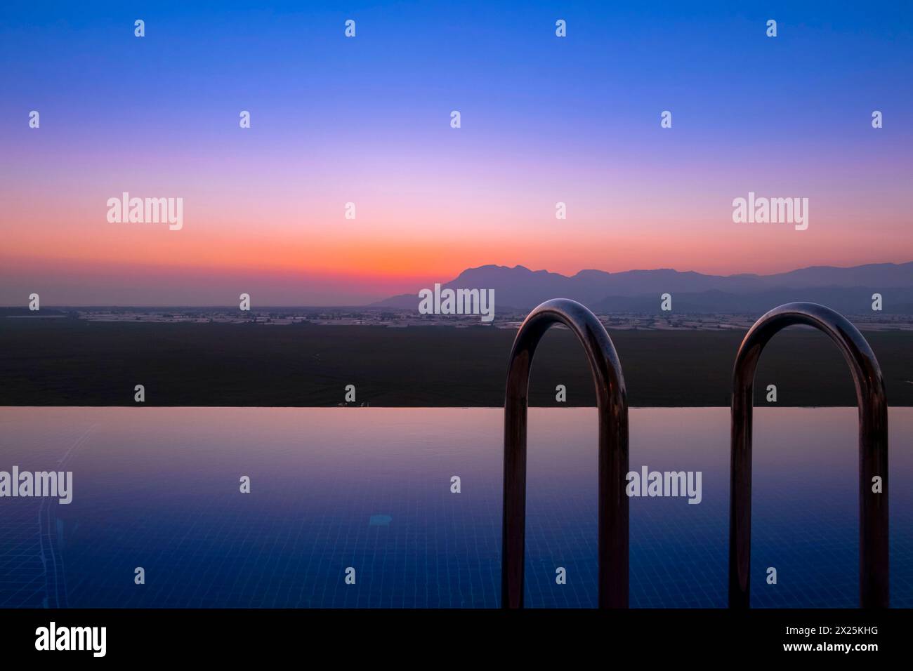 Sunset long exposure blue hour shot with infinity pool in Kas Antalya Stock Photo