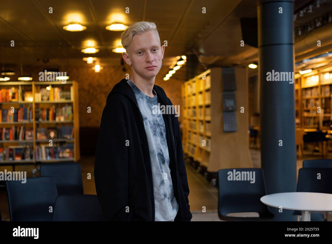 a young handsome guy studies in a co-working space. Library for students Stock Photo
